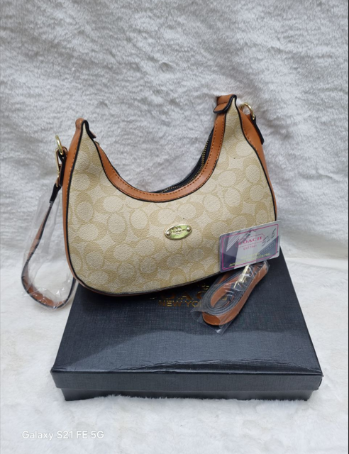 Coach-New-York-women-handbag-with-the-signature-monogram-pattern
